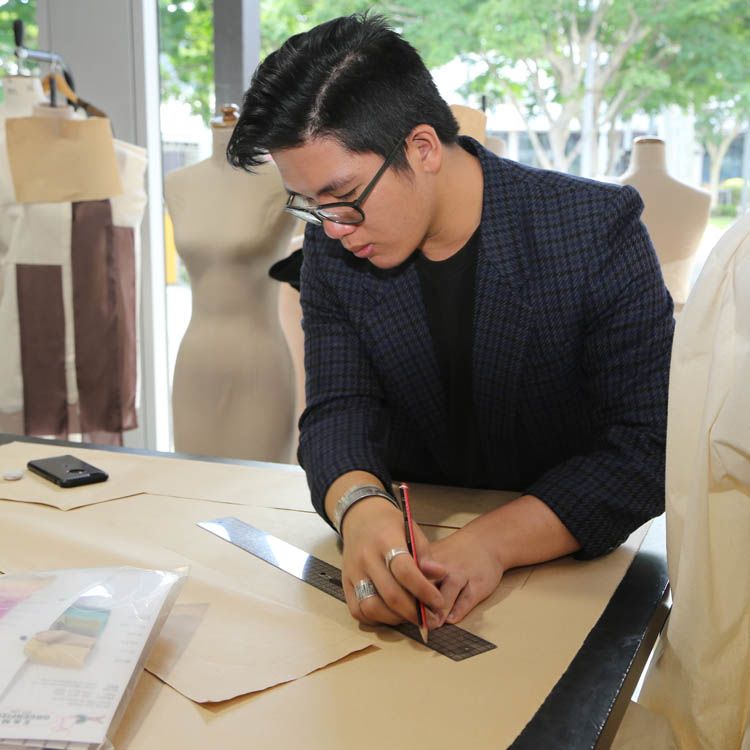 Fashion graduate and Woolmark Scholarship recipient Joash Teo works in QUT's studios based in Kelvin grove, Brisbane.  